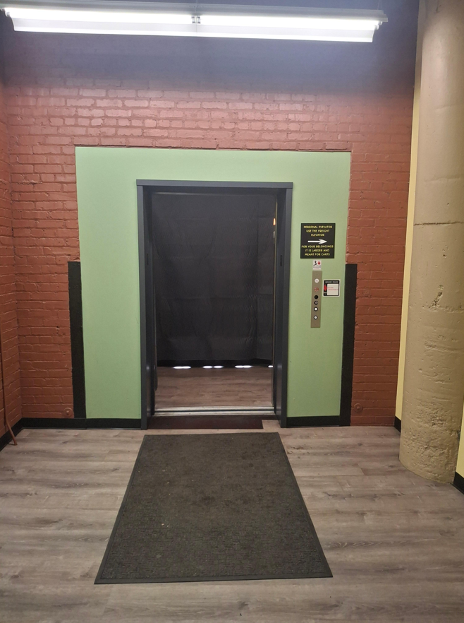 Heated Storage Interior & Elevator Access Interior Corridor Elevator Entrance with Freight Elevator Signage
